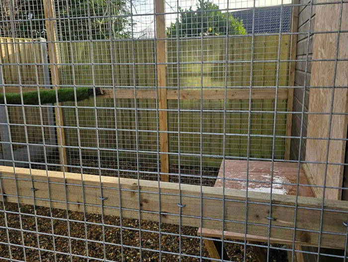 Agricultural fencing enclosure in Plymouth featuring secure mesh panels and timber framing for livestock.