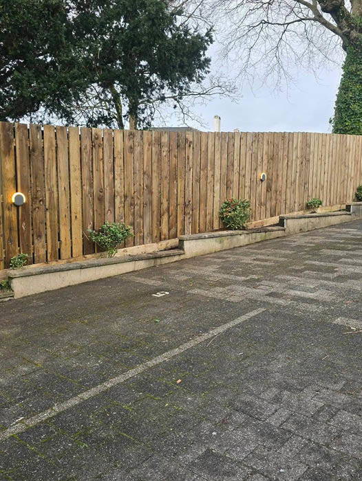 Timber parking‑bay fence installed by a Plymouth fencing contractor with lights and raised planter. Timber parking‑bay fence installed by a Plymouth fencing contractor with lights and raised planter.