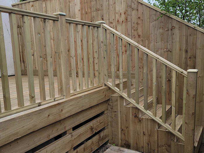 Timber decking and fence installation in Plymouth featuring a new wooden deck, stairs and privacy screen.